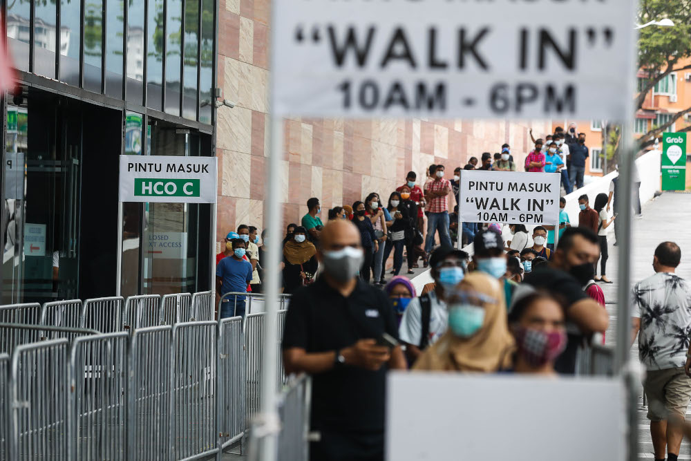 Hundreds of foreigners pictured queuing as they wait for their turn to get the first dose of the Covid-19 vaccine at Subterranean Penang International Convention and Exhibition Centre, Bayan Baru, September17, 2021. u00e2u20acu201d Picture by Sayuti Zainudin