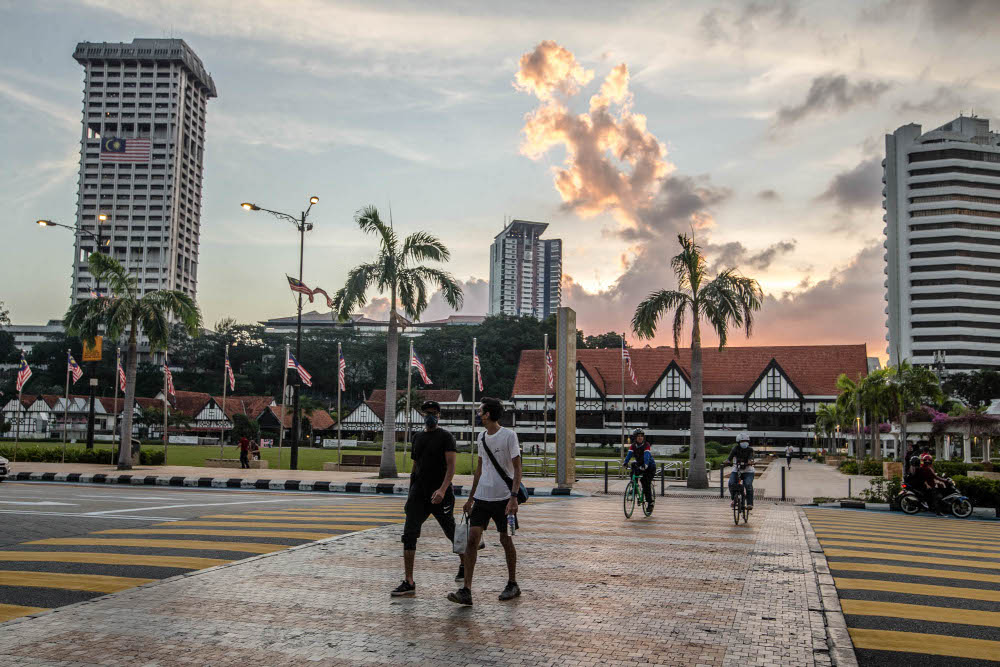 People wearing face masks walk on a street in Kuala Lumpur, September 21, 2021. u00e2u20acu201d Picture by Firdaus Latif