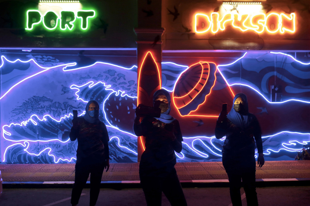 Visitors take a selfie in front of a lighted mural in Jalan Raja Aman Shah in Port Dickson, September 11, 2021. u00e2u20acu201d Bernama pic 