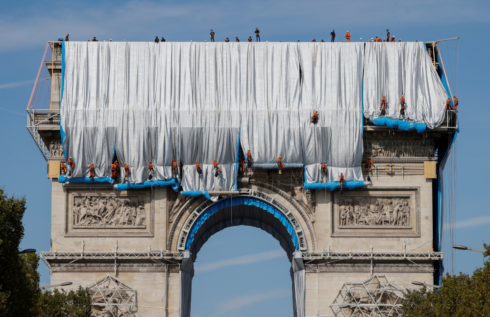 Workers install a shimmering wrapper to envelop Paris landmark, the Arc de Triomphe, in a posthumous installation by artist Christo on the Champs Elysee avenue, in Paris September 12, 2021. u00e2u20acu201d Reuters pic