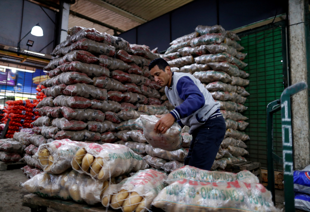 Eduardo David Rodriguez, 40, loads bags of potatoes at the Mercado Central where he works twice a week earning 12,000 Argentine Pesos (RM251) a month, in Buenos Aires September 28, 2021. u00e2u20acu201d Reuters pic