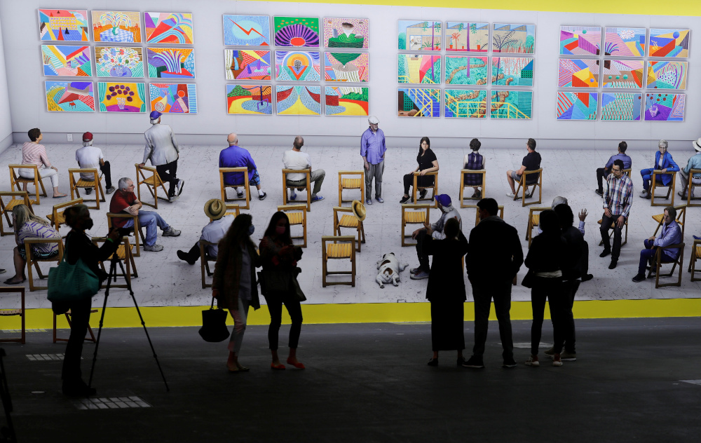 People stand in front of the painting u00e2u20acu02dcPictures at an exhibitionu00e2u20acu2122 from 2018/2021 by artist David Hockney at the Art Unlimited exhibition at the Art Basel art fair in Basel September 21, 2021. u00e2u20acu201d Reuters pic