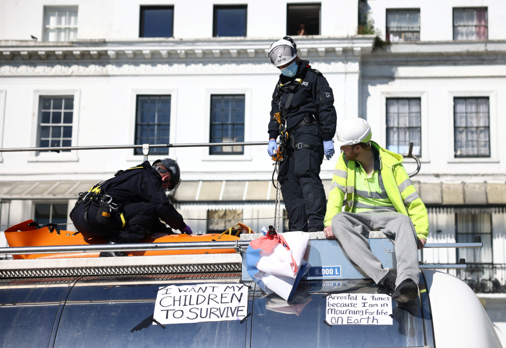 Police officers prepare to remove a protestor of the group u00e2u20acu02dcInsulate Britainu00e2u20acu2122 from the roof of a lorry at the entrance of Port of Dover September 24, 2021. u00e2u20acu201d Reuters pic