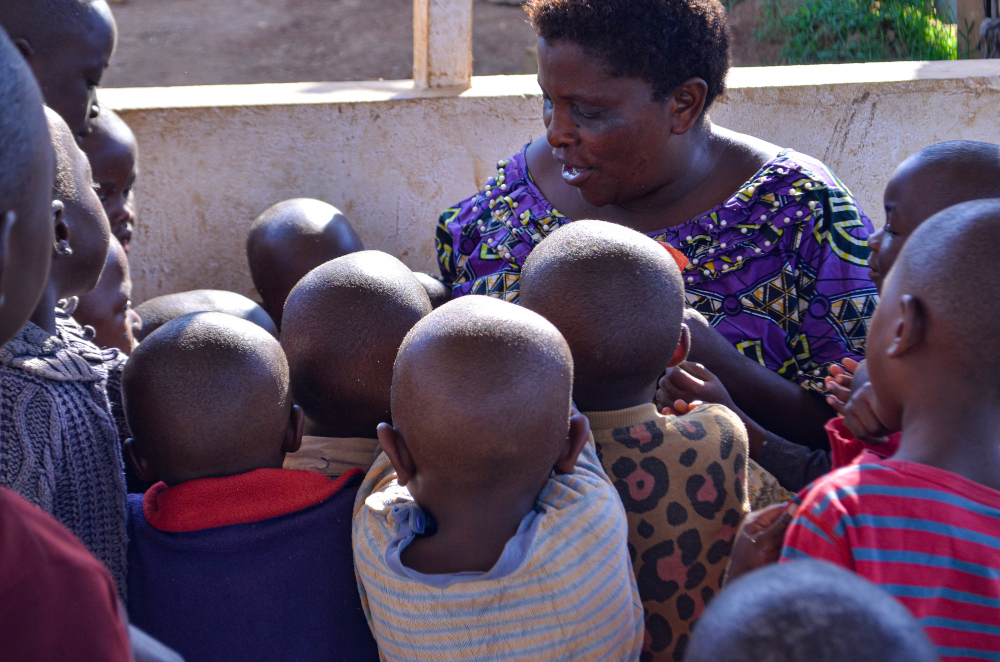 Orphanage director Dorcas Mbambu distributes candy to Ebola orphans at the House of Compassion for Children in Need in Butembo, Democratic Republic of Congo, August 26, 2021. — Djiress Baloki/Thomson Reuters Foundation pic