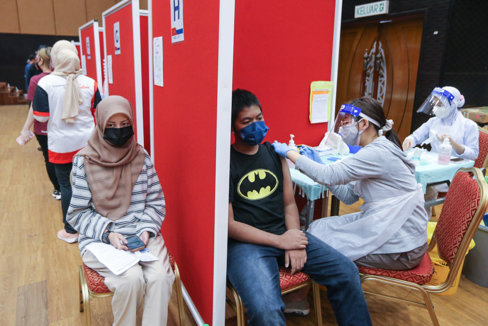Form 4 and 5 students receive their first dose of the Covid-19 vaccine at MSU University in Shah Alam, September 22, 2021. u00e2u20acu201d Picture by Ahmad Zamzahuri