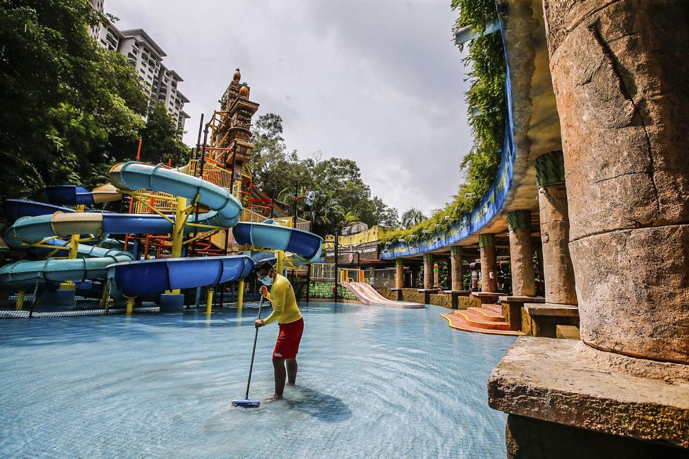 A worker is pictured getting the Sunway Lagoon theme park ready to reopen to visitors in Subang Jaya September 27, 2021. — Picture by Hari Anggara