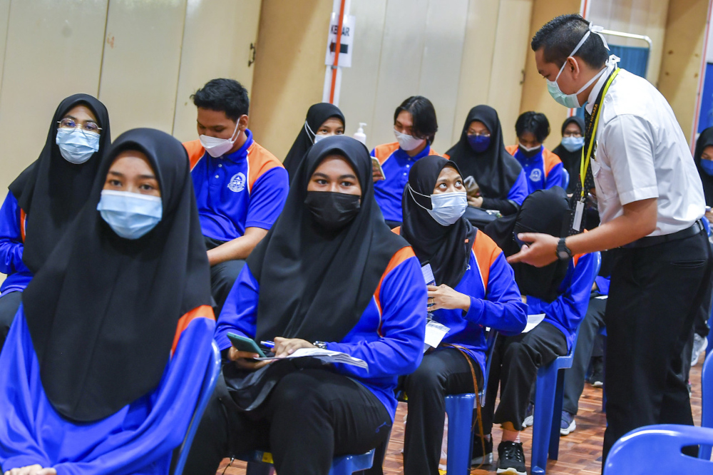 Health staff monitoring students in the observation section after receiving their Covid-19 vaccine at Sekolah Menengah Kebangsaan Putrajaya Precinct 8 (1), September 20, 2021. u00e2u20acu201d Bernama pic 