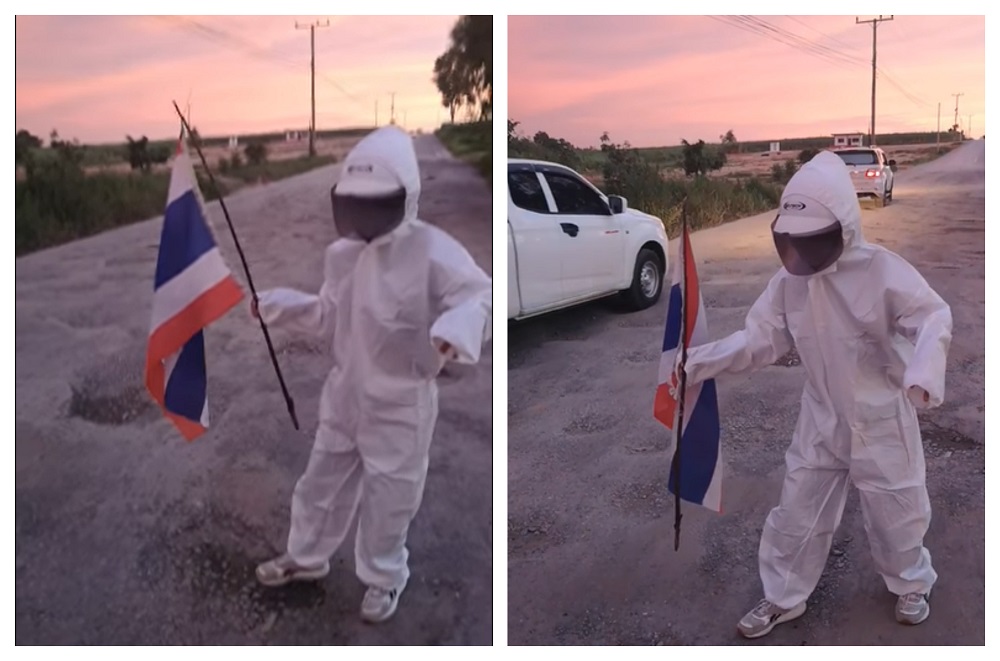 Wansueb wearing her astronaut outfit while walking on the road filled with potholes. u00e2u20acu2022 Picture via Facebook/AomamChaluayjit Wansueb