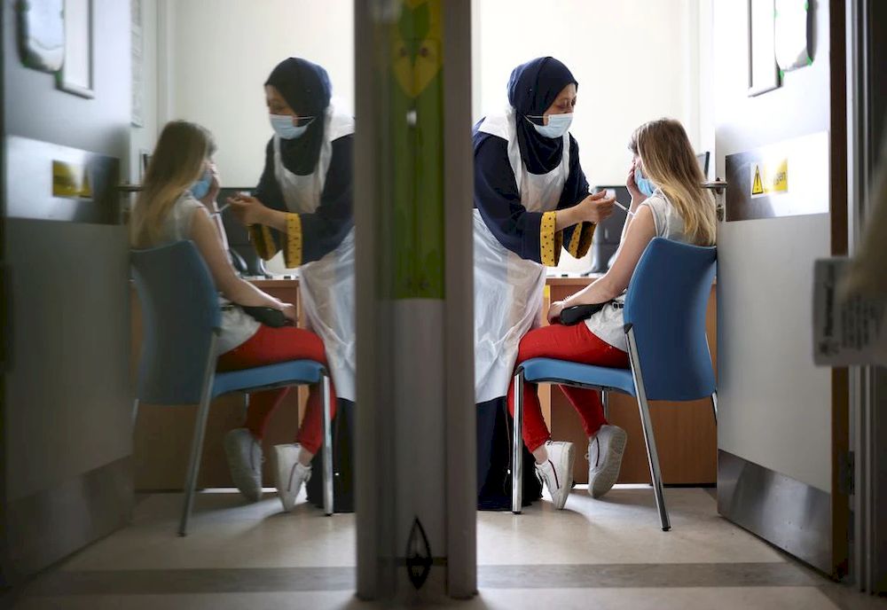 A person receives a dose of the Pfizer BioNTech vaccine at the Central Middlesex Hospital in London, Britain, August 1, 2021. u00e2u20acu201d Reuters pic