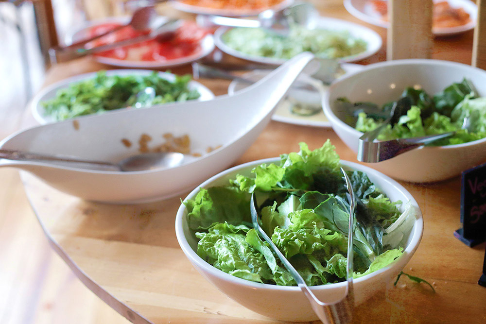 The breakfast buffet table is a great place to prepare your breakfast burritos... and even sneak some greens in!