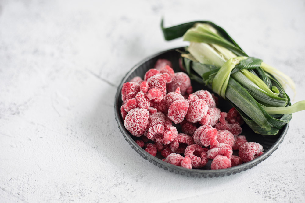 Frozen raspberries and pandan leaves.