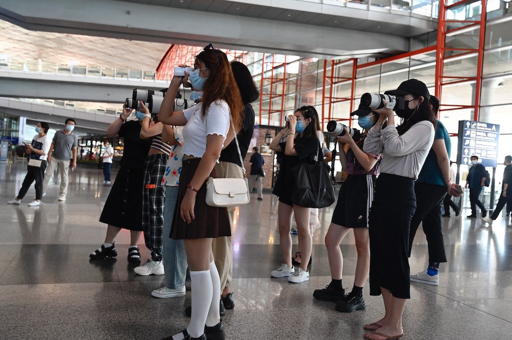 This file photo taken on August 25, 2021 shows fans holding cameras waiting for celebrities at Beijingu00e2u20acu2122s Capital Airport in Beijing. u00e2u20acu201d AFP pic