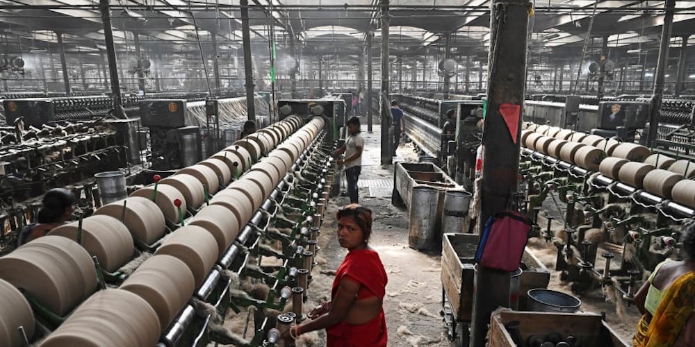 Labourers work at a private jute mill in Jagatdal. u00e2u20acu201d AFP pic