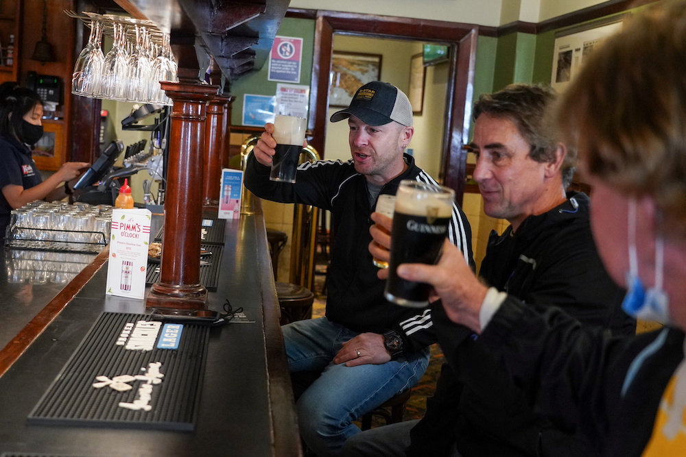 Customers Brian O'Mara, Darrell Forman and Doug Thomas drink beers together at the Fortune of War pub, on the first morning of pubs and many other businesses re-opening to vaccinated people in Sydney October 11, 2021. u00e2u20acu201d Reuters pic