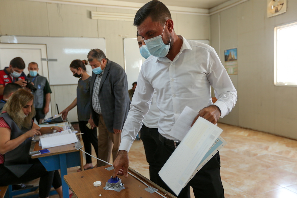 Darwesh Khodeda Hassan, a displaced Yazidi man, casts his vote at a polling station, two days ahead of Iraq's parliamentary elections in a special process, at the Sharya camp in Duhok, Iraq October 8, 2021. u00e2u20acu201d Reuters pic
