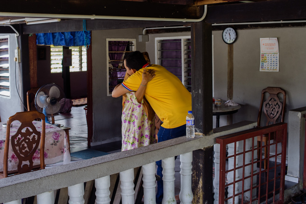 Taufik hugs his mother, Jamilah Damyati, after he made a surprise visit to his hometown in Bagan Datuk. u00e2u20acu201d Picture by Shafwan Zaidon