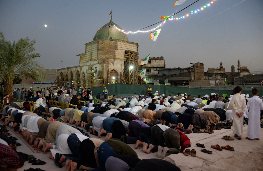 Iraqis kneel to pray in the courtyard of the war-ravaged landmark al-Nuri mosque, in the northern city of Mosul October 17, 2021, for the first time since the 2017 defeat of the Islamic State (IS) group. u00e2u20acu201d AFP pic
