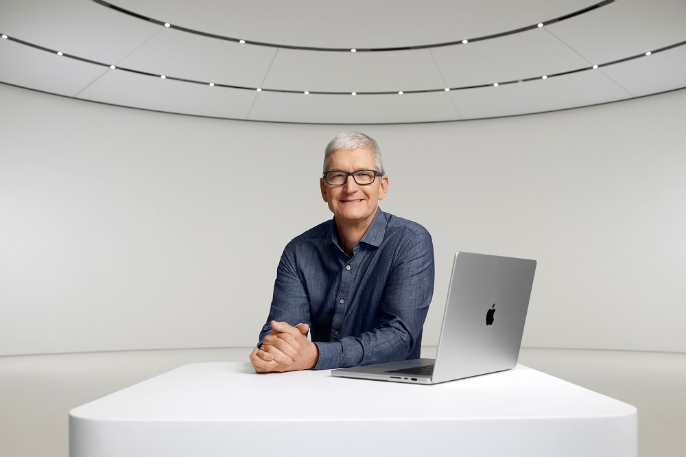 Apple CEO Tim Cook poses with a new MacBook Pro for Appleu00e2u20acu2122s Unleashed 2021 event at Apple Park in Cupertino, California in a photograph released October 18, 2021. u00e2u20acu201d Picture by Apple Inc/Handout via Reuters