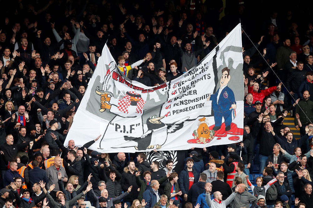 Crystal Palace fans with a banner in reference to the Newcastle takeover from a Saudi Arabia-led consortium, at Selhurst Park in London October 23, 2021. u00e2u20acu201d Action Images via Reuters