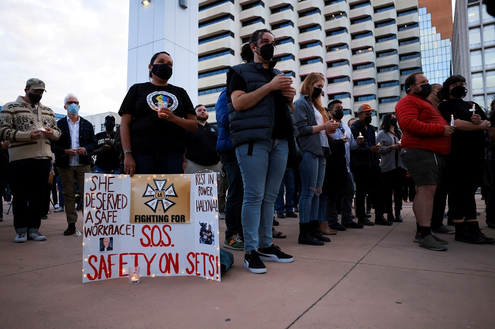 A woman displays a sign calling for workplace safety at a vigil for cinematographer Halyna Hutchins, who died after being shot by Alec Baldwin on the set of his movie u00e2u20acu02dcRustu00e2u20acu2122, in Albuquerque, New Mexico  October 23, 2021. u00e2u20acu201d Reuters pic