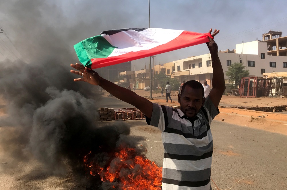 A protester waves a flag during what the information ministry calls a military coup in Khartoum, Sudan October 25, 2021. u00e2u20acu201d Reuters pic