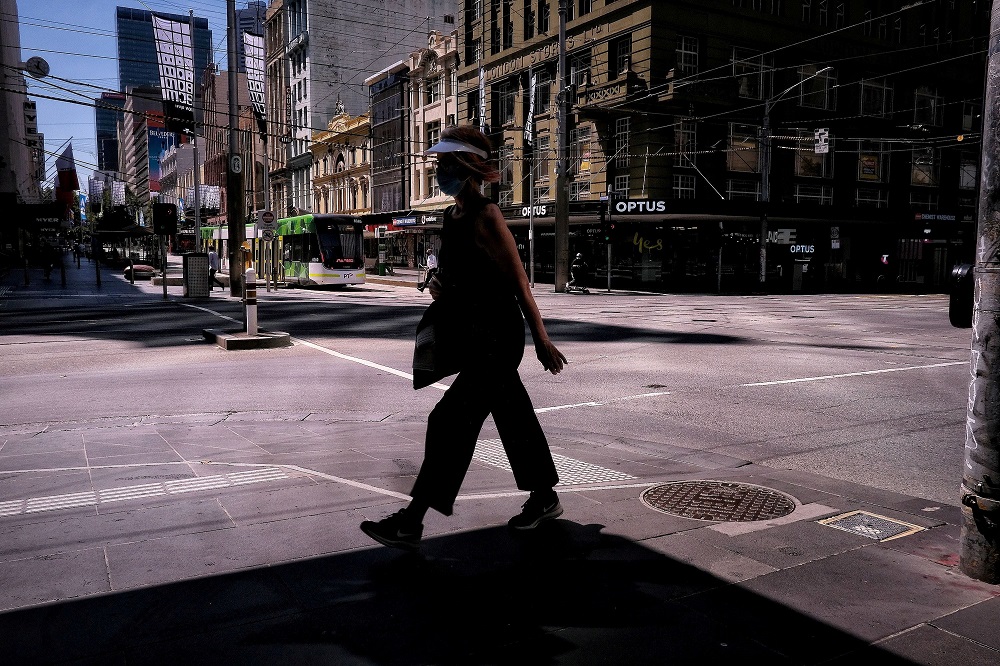 A woman walks on a street, amid a state-wide lockdown, in Melbourne city centre, Victoria February 15, 2021. u00e2u20acu201d AAP Image via Reuters