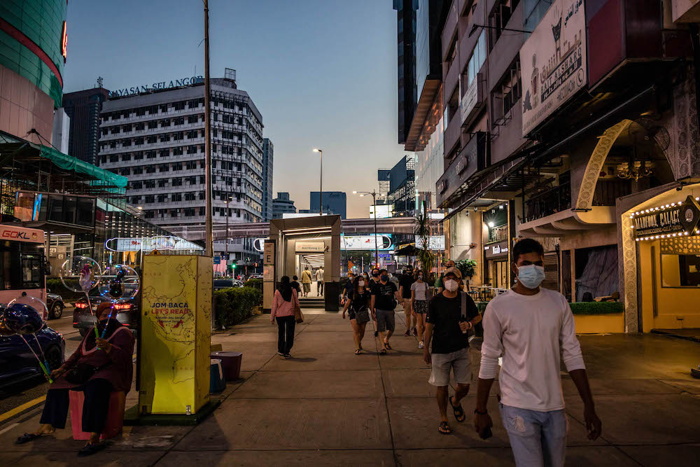 People are seen wearing protective masks as they walk along the Bukit Bintang shopping area in Kuala Lumpur on October 9, 2021. u00e2u20acu201d Picture by Firdaus Latif