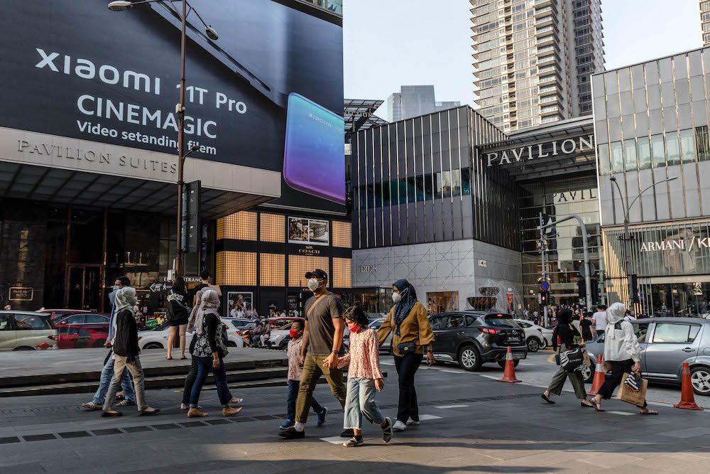 People are seen wearing protective masks as they walk along the Bukit Bintang shopping area in Kuala Lumpur on October 9, 2021. u00e2u20acu201d Picture by Firdaus Latif