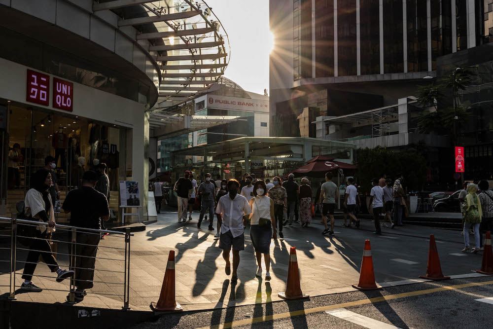 People are seen wearing protective masks as they walk along the Bukit Bintang shopping area in Kuala Lumpur on October 9, 2021. u00e2u20acu201d Picture by Firdaus Latif