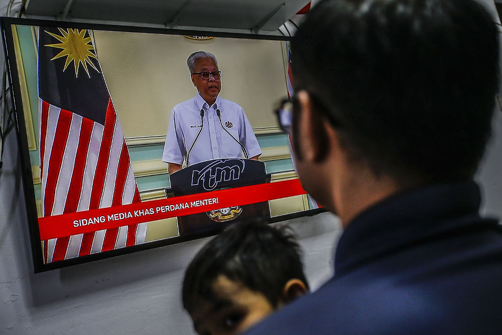 A family watches the live telecast of Prime Minister Datuk Seri Ismail Sabri October 10, 2021. u00e2u20acu2022 Picture by Hari Anggara