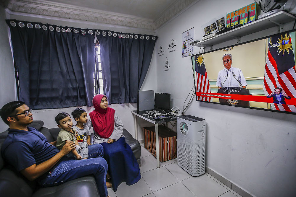 A family watches the live telecast of Prime Minister Datuk Seri Ismail Sabri October 10, 2021. u00e2u20acu2022 Picture by Hari Anggara