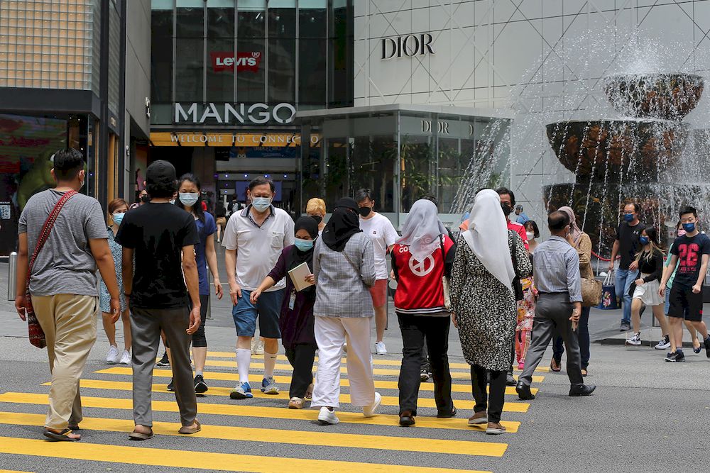 People wearing face masks cross the road in front of Pavillion in Kuala Lumpur October 10, 2021. u00e2u20acu201d Picture by Yusof Mat Isa
