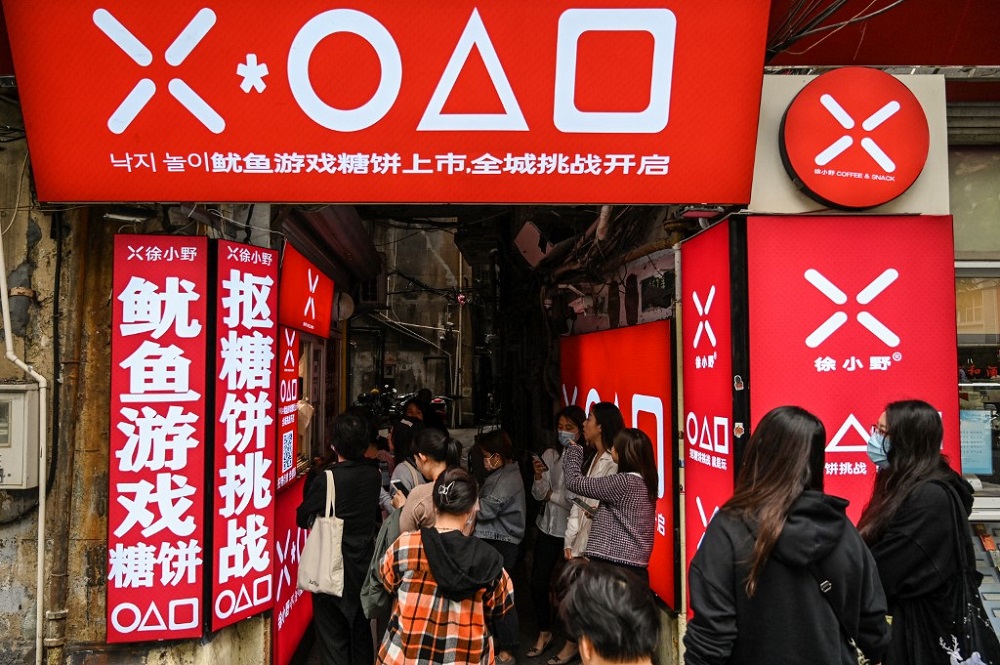 Customers waiting at a small shop for dalgonas, a crisp sugar candy featured in the Netflix series u00e2u20acu02dcSquid Gameu00e2u20acu2122, in Shanghai October 12, 2021. u00e2u20acu201d AFP pic