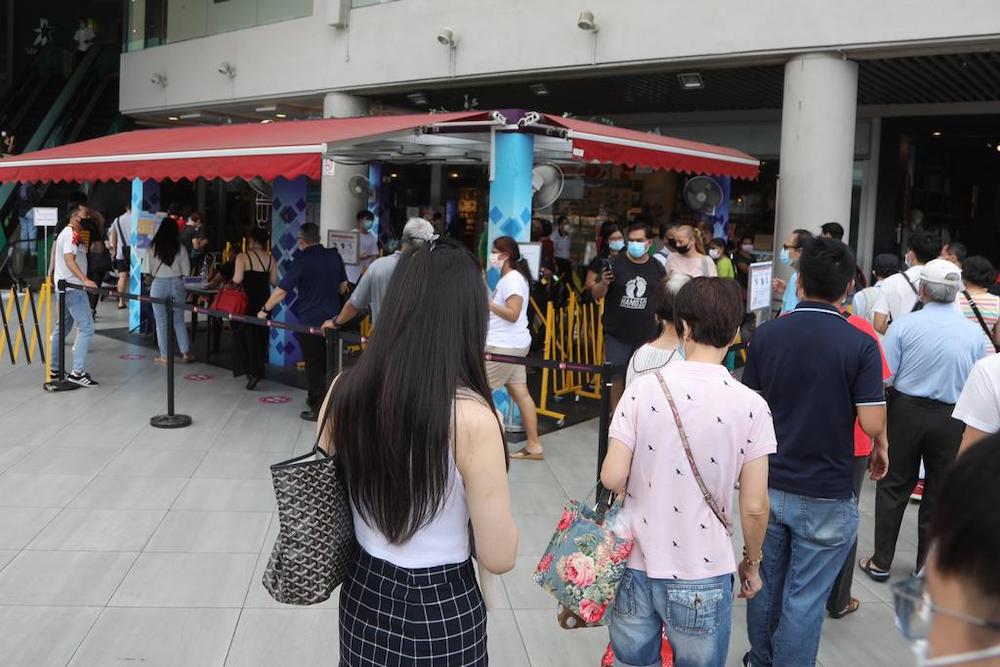 Due to checks on vaccination status, a long line of people were waiting to enter Tampines Mall on Oct 13, 2021. u00e2u20acu201d TODAY pic