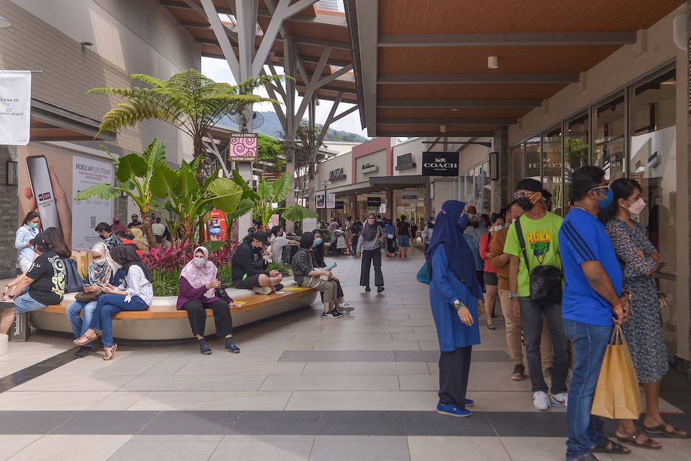 People spend time shopping with their families at Genting Premium Outlet shopping mall in Genting Highland during the first weekend of interstate travel restriction lifted on October 16, 2021. u00e2u20acu201d Picture by Miera Zulyana