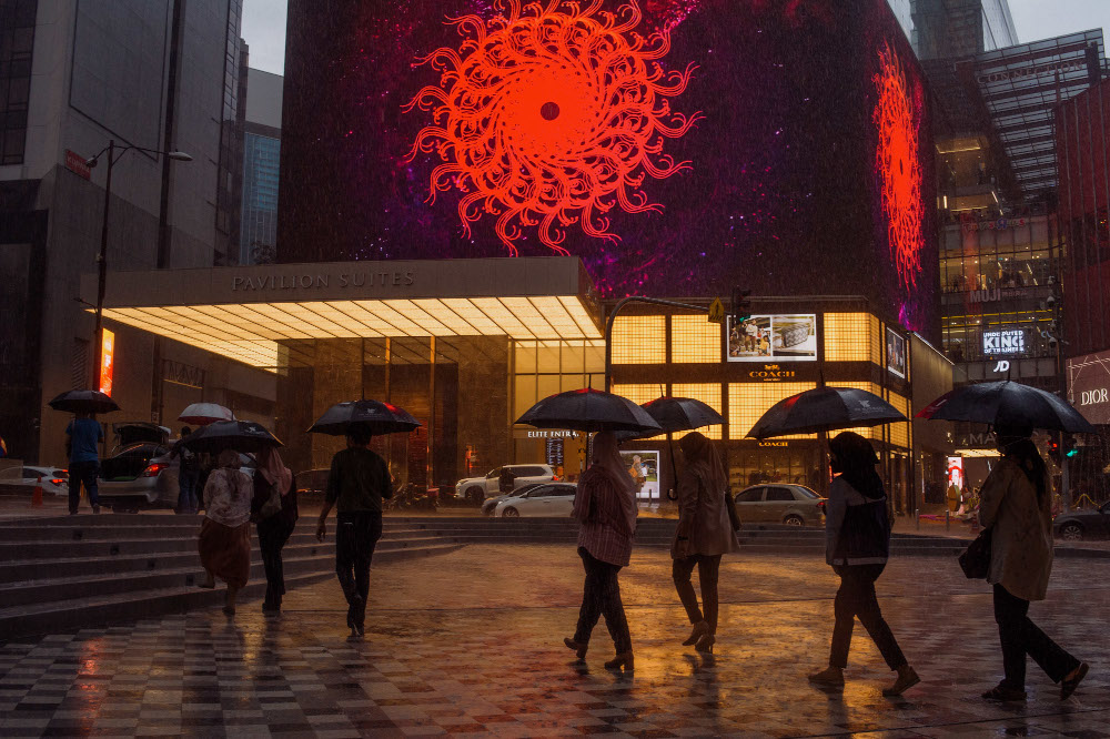 Pedestrians walking on the sidewalk while holding umbrellas in Bukit Bintang, Kuala Lumpur October 23, 2021. u00e2u20acu201d Picture by Shafwan Zaidon