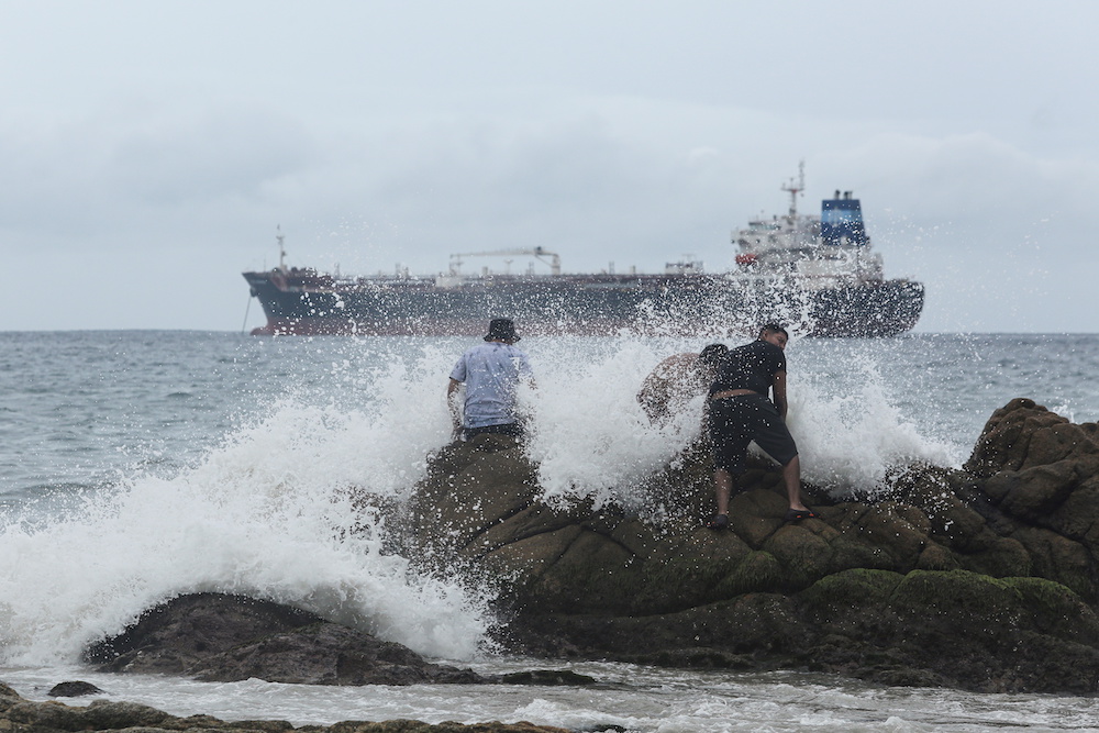 People are pictured on a beach as tropical Storm Rick strengthened into a hurricane off Mexico's Pacific coast, in Acapulco, Mexico October 23, 2021. u00e2u20acu201d Reuters pic