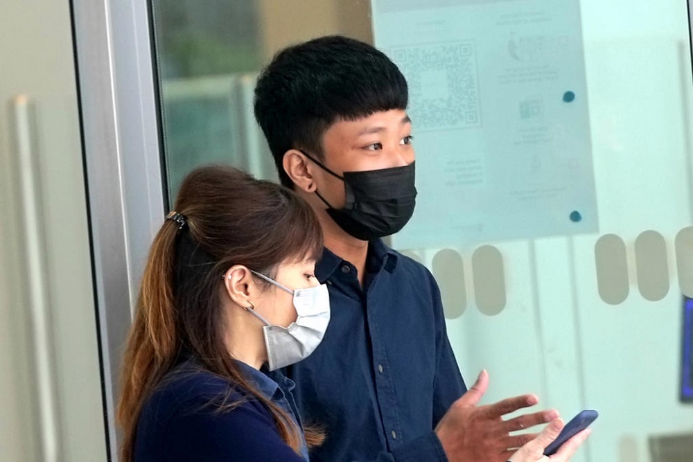 Shawn Tan Jia Jun (right) outside the State Courts in Singapore October 25, 2021. u00e2u20acu201d TODAY pic