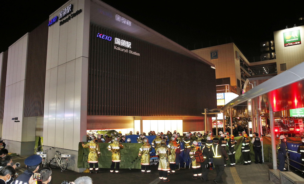 Rescue workers and police officers work at the site where a knife, arson and acid attack incident occurred on a train, at the Kokuryo station of the Keio Line train in Tokyo, Japan October 31, 2021 in this photo taken by Kyodo. u00e2u20acu201d  Kyodo pic via Reutersn