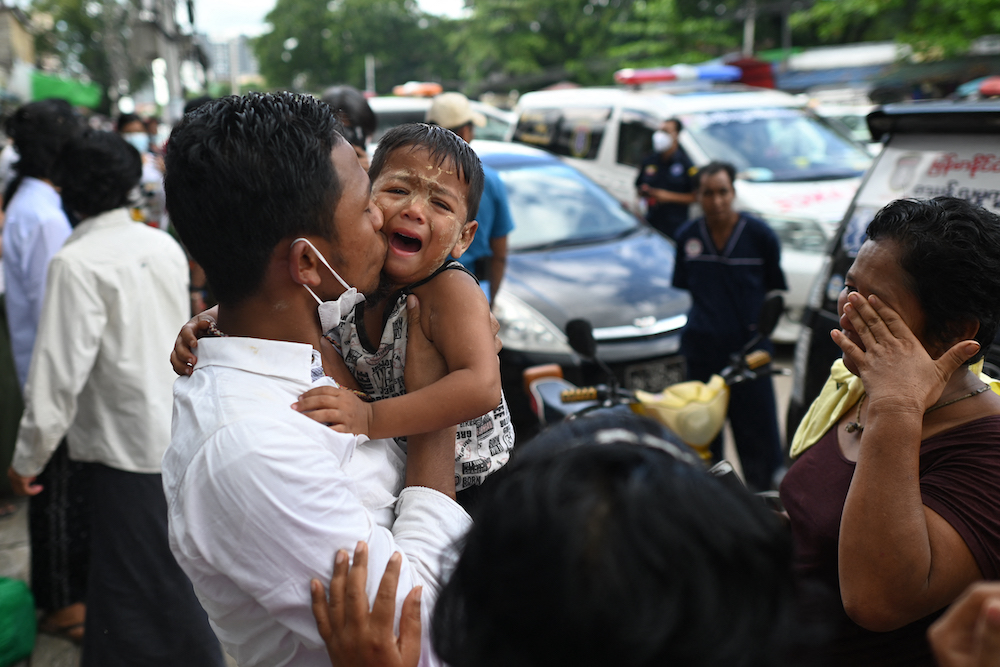 A man celebrates with relatives after being released from Insein Prison in Yangon on October 19, 2021, as authorities released thousands of people jailed for protesting against a February coup that ousted the civilian government. u00e2u20acu201d AFP pic