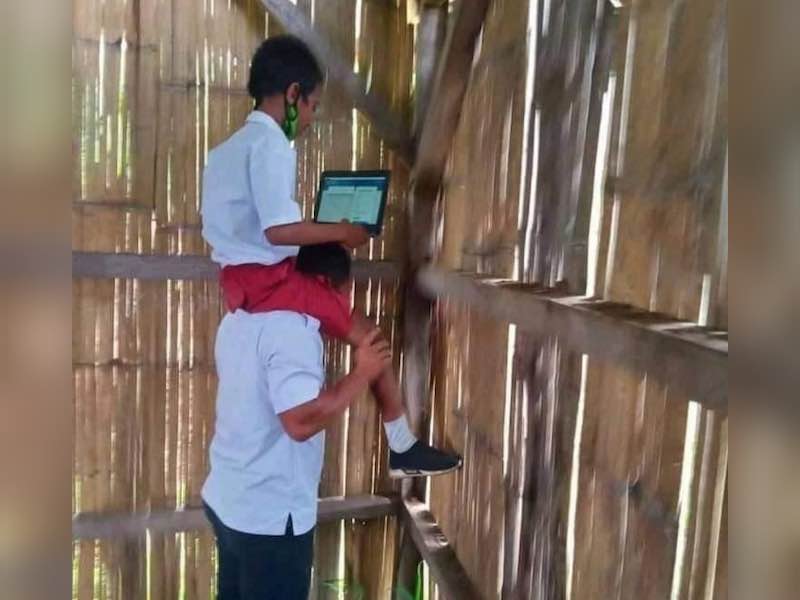 A teacher in Indonesia carried a pupil on his shoulders so the boy could have better internet access. u00e2u20acu201d Picture via Instagram/ nttupdate