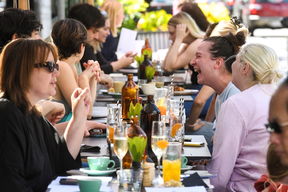 People enjoy a meal at a cafe in Melbourne following the midnight lifting of coronavirus restrictions in one of the world's most locked-down cities, October 22, 2021. u00e2u20acu201d AFP pic