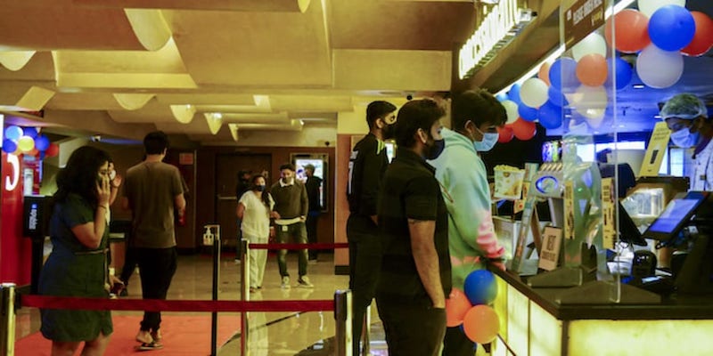 Cinema-goers queue up to buy snacks during intermission time at a cinema theatre in Mumbai October 22, 2021. u00e2u20acu201d AFP pic
