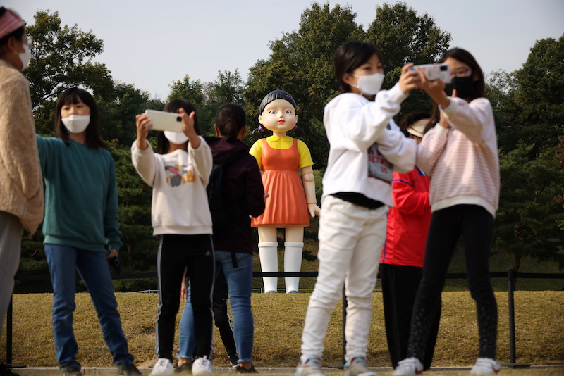People take a selfie with a giant doll named 'Younghee' from Netflix series 'Squid Game' on display at a park in Seoul, South Korea October 26, 2021. u00e2u20acu201d Reuters pic
