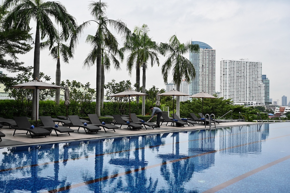 This photo taken on October 19, 2021 shows staff cleaning the pool at the Chatrium Riverside Hotel in Bangkok. u00e2u20acu201d AFP pic