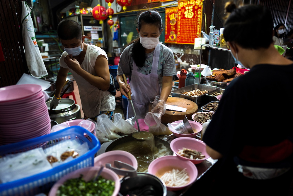 Adulwitch Tangsupmanee, and Jirintat, son and daughter of Chanchai Tangsupmanee, who died at age 73 of Covid-19 in July, prepare meals at their late father's food stall in Bangkok's Chinatown, Thailand October 6, 2021. u00e2u20acu201d Reuters pic