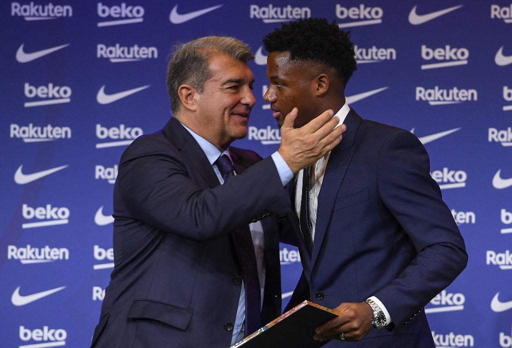 Barcelonau00e2u20acu2122s Spanish midfielder Ansu Fati is greeted by President of FC Barcelona Joan Laporta during his contract renewal signing ceremony in Barcelona, on October 21, 2021. u00e2u20acu201d AFP pic