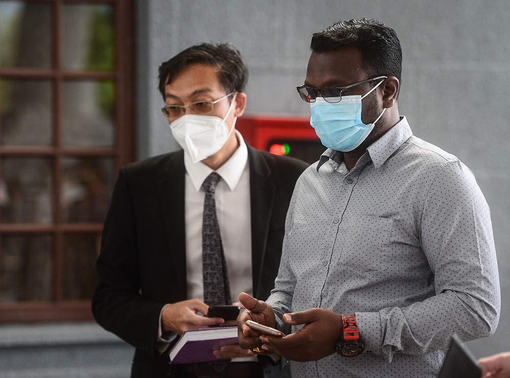 Malaysia-Singapore Workers Task Force chairman S. Dayalan (right) at the Sessions Court in Kuala Lumpur October 12, 2021. u00e2u20acu201d Bernama pic