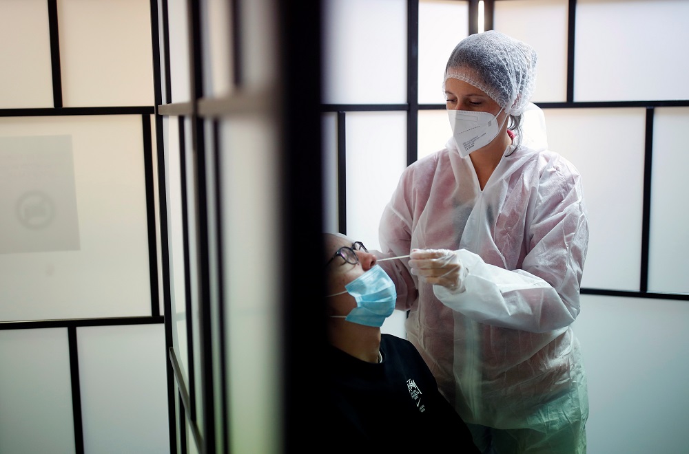 A medical worker administers a nasal swab to a patient at a Covid-19 testing centre in Les Sorinieres near Nantes in France October 15, 2021. u00e2u20acu2022 Reuters pic