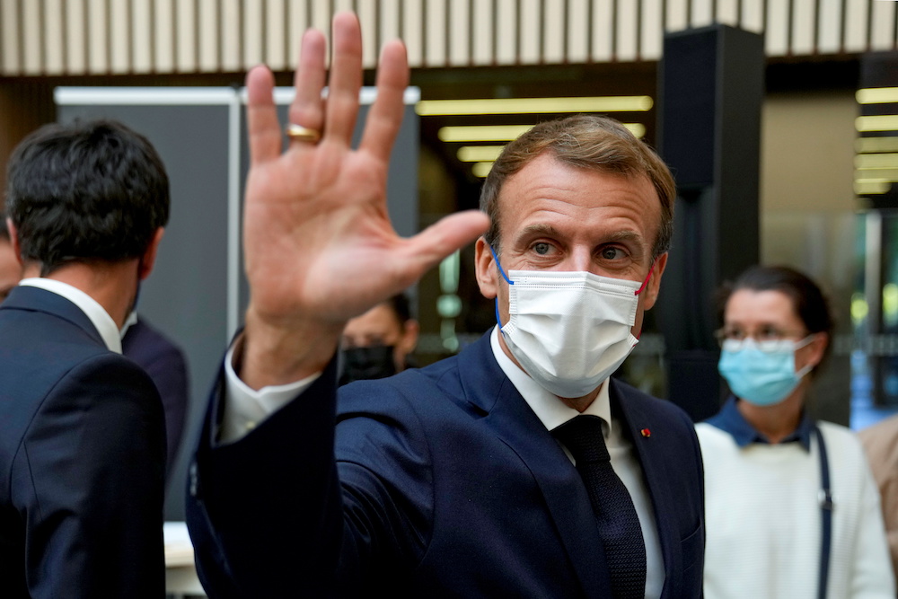 French President Emmanuel Macron waves after his visit at the headquarters of the Paris 2024 Organizing Committee, in Saint Denis, outside Paris, France October 14, 2021. u00e2u20acu2022 Reuters pic